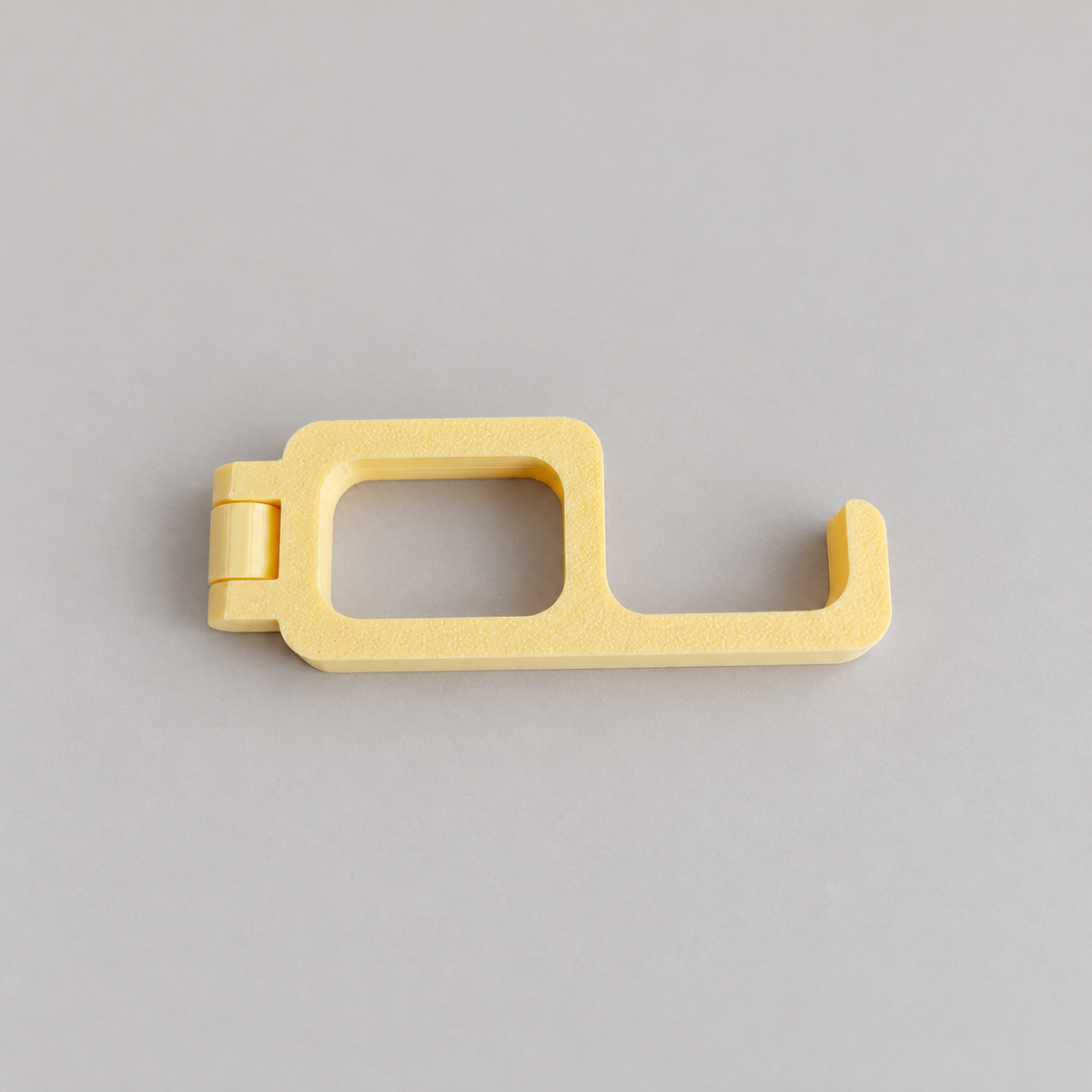 fold-closed: original phone stand photograph, matte PLA surface and 3D printed layer details