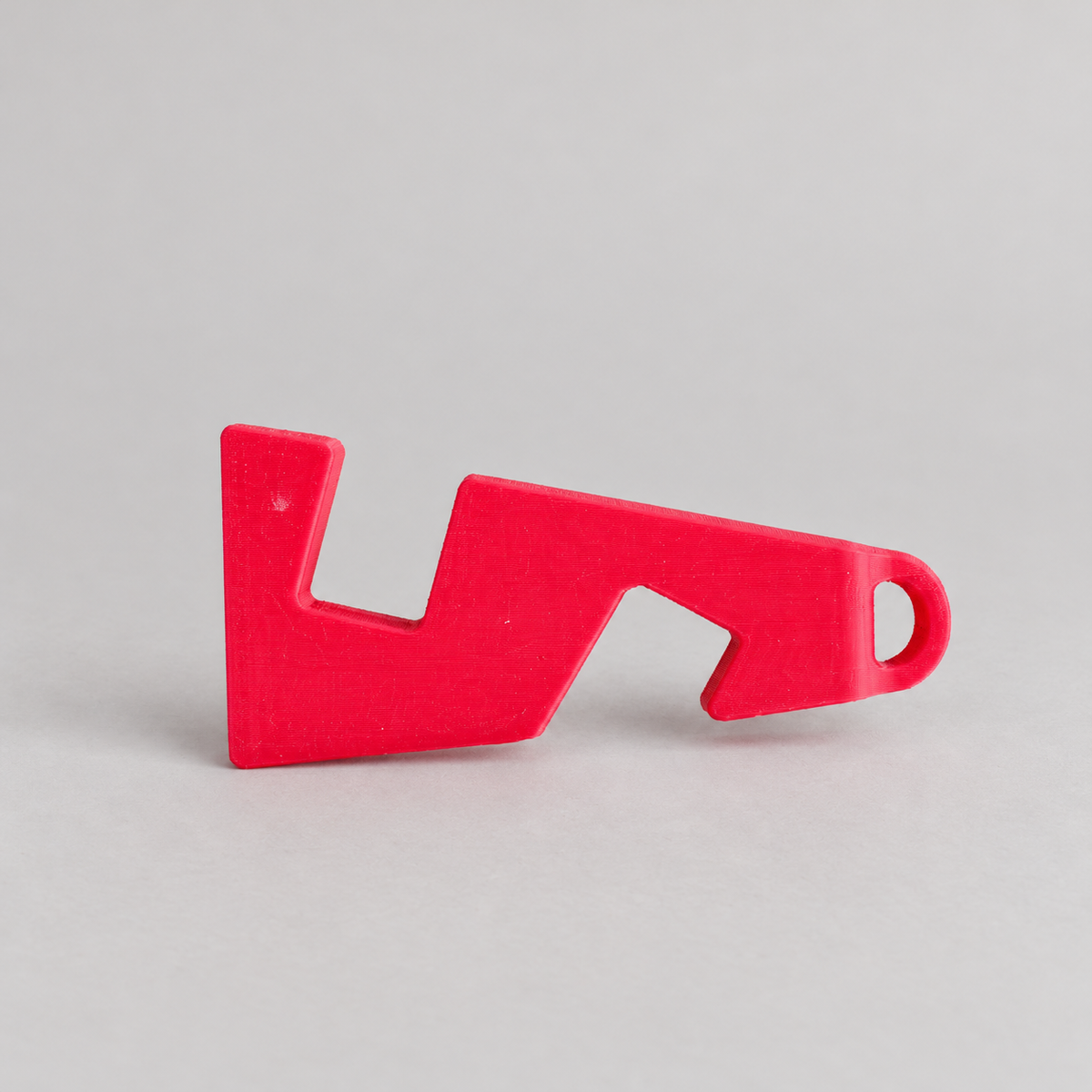 mini-closed: original phone stand photograph, matte PLA surface and 3D printed layer details