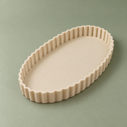 Elevated diagonal view of the oval beige trinket tray with a continuous wavy rim and visible 3D print texture