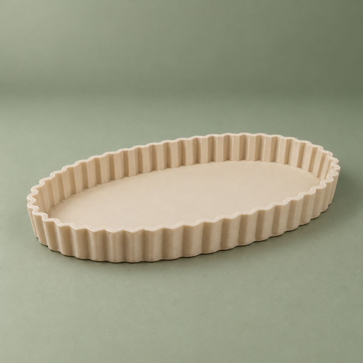 Low angled view of the beige matte PLA oval tray showing the shallow fluted wall and flat interior